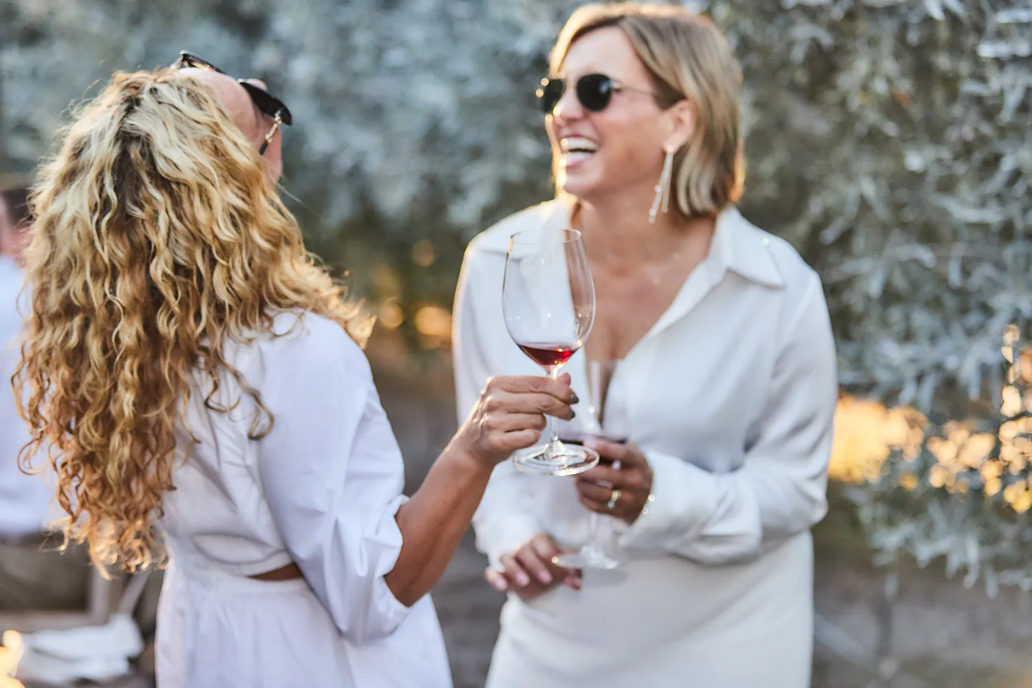 image of people smiling with wine glasses